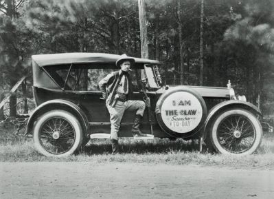 photographer unknown A Texas Ranger by his car with sign 