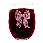 texas Wine glass with pink studded bow, full of liquid
